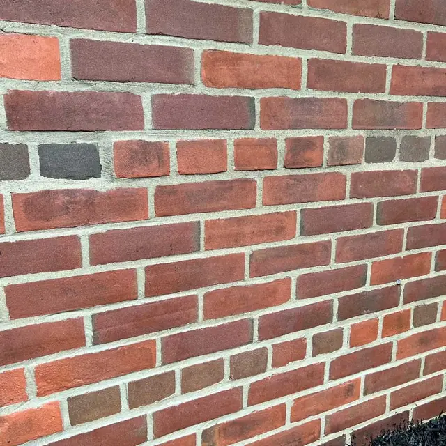A brick wall after damaged bricks were replaced
